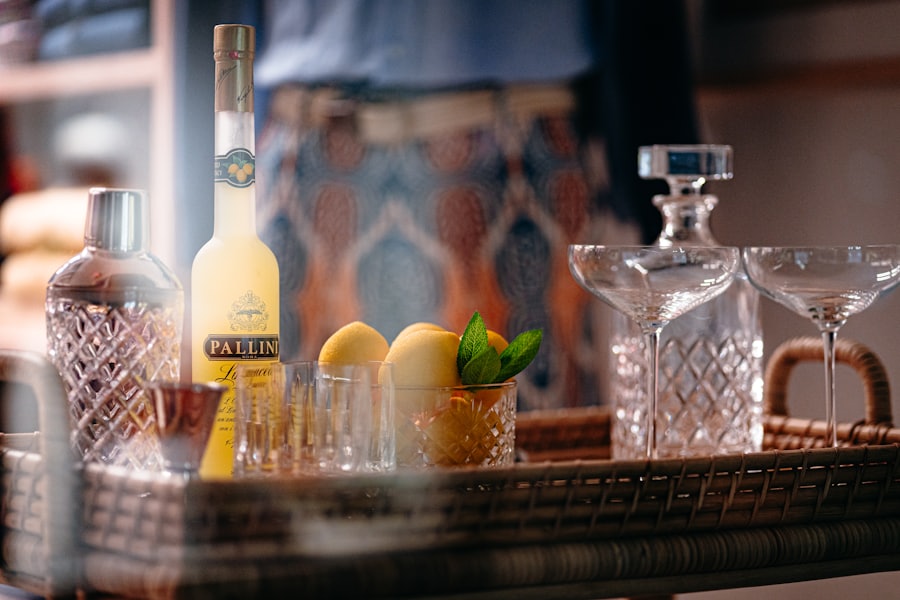 A cocktail tray with crystal glassware, a decanter and fresh citrus in a warmly lit lounge.